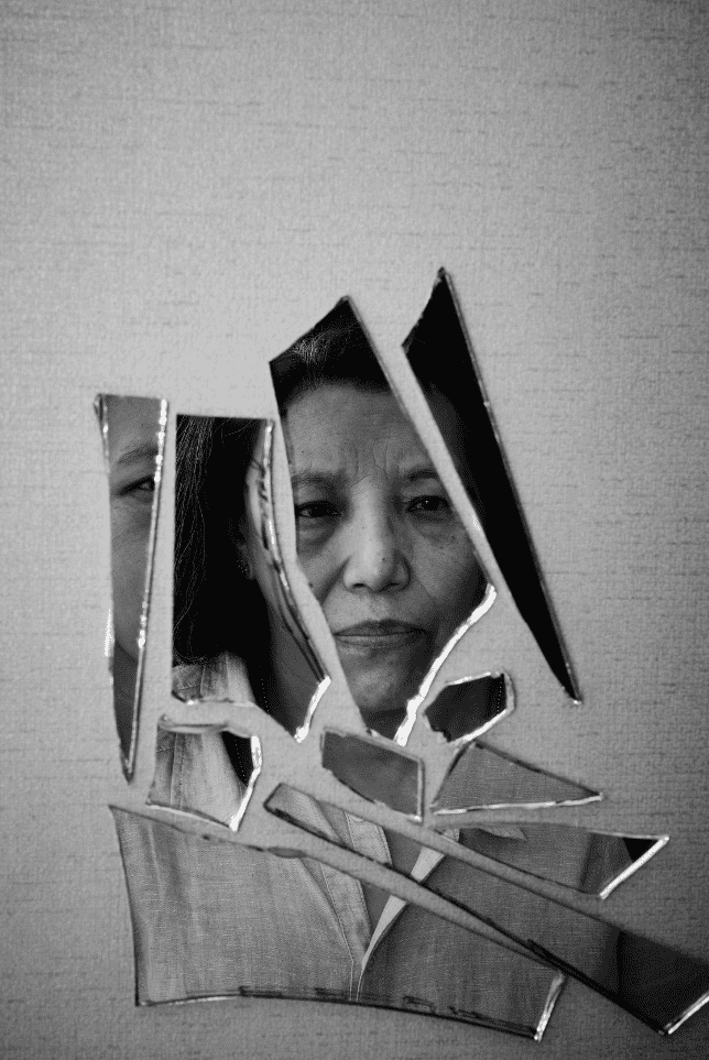 Reflection of a Woman on Broken Mirror