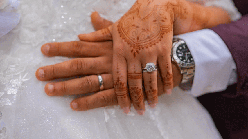 Classic commitment ring and a wedding band for newly wed couple