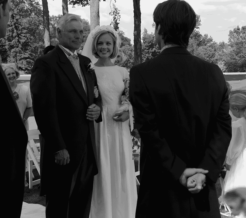 Bride walking down the aisle with her father, groom waiting at the altar.