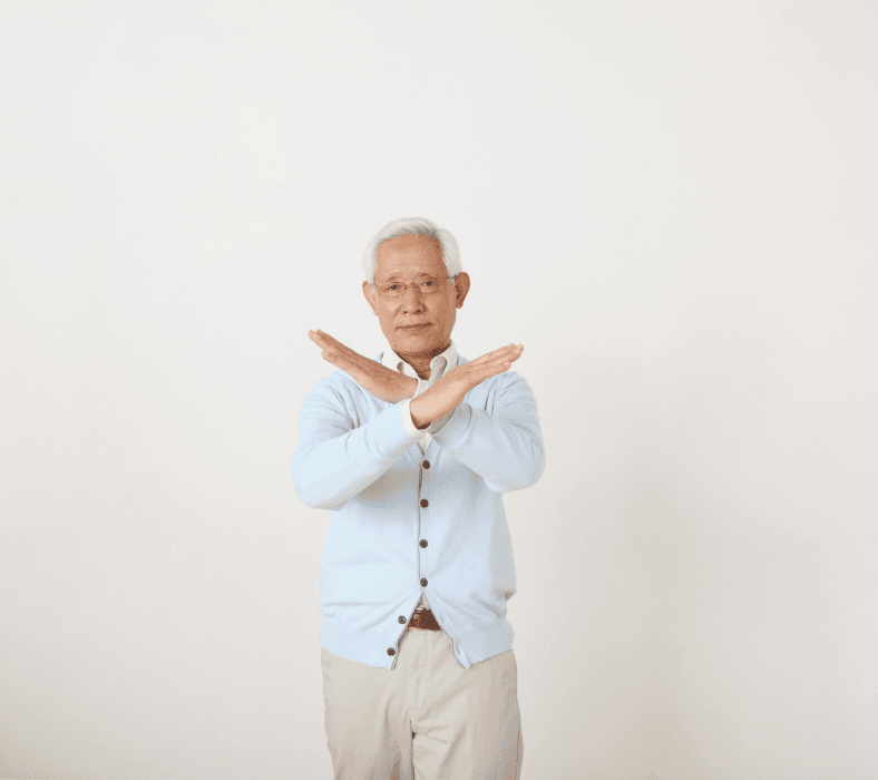 Elderly father crossing his arms in rejection, disapproving a marriage proposal.