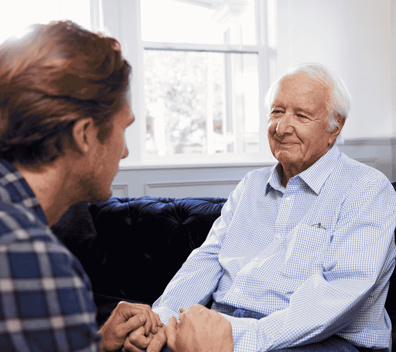 Young man asking an elderly father for permission to marry his daughter.