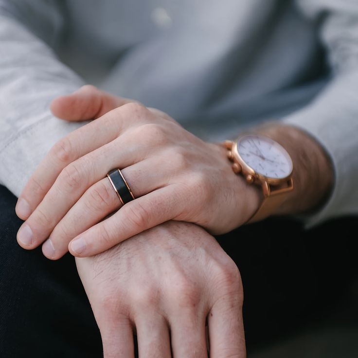 A Man wearing The Goldrush Black and Gold Tungsten Ring with a Gold Watch.