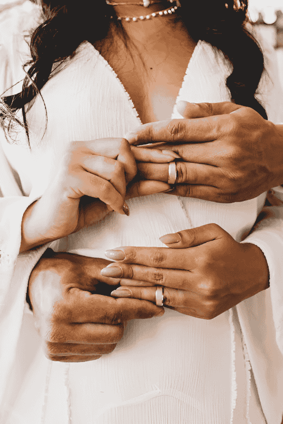 Couple Holding Each Other Rings